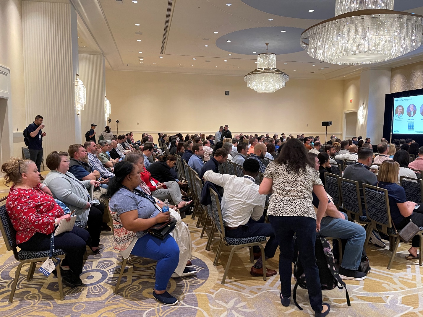 A group of people sitting in chairs Description automatically generated with medium confidence